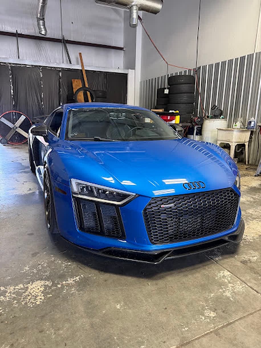 Blue Audi R8 in the service bay at Unlimited Tire & Service